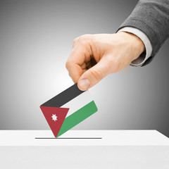 Voting concept - Male inserting flag into ballot box - Jordan