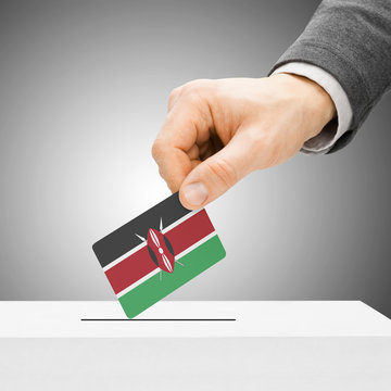 Voting concept - Male inserting flag into ballot box - Kenya