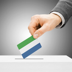 Voting concept - Male inserting flag into ballot box - Sierra Le
