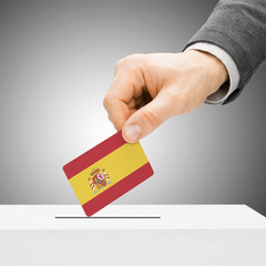 Voting concept - Male inserting flag into ballot box - Spain