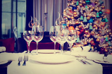 Place setting with Christmas tree in background, toned
