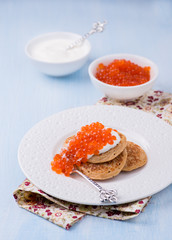 Buckwheat blini with red caviar and sour cream