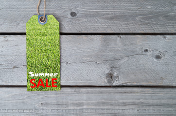 Summer sale concept with a sale tag on wooden table