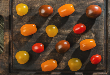 Variety of cherry tomatoes on wood