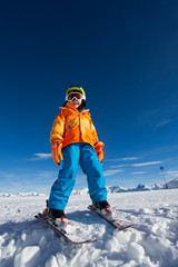 Fototapeta na wymiar Smiling boy wearing ski mask and helmet in winter