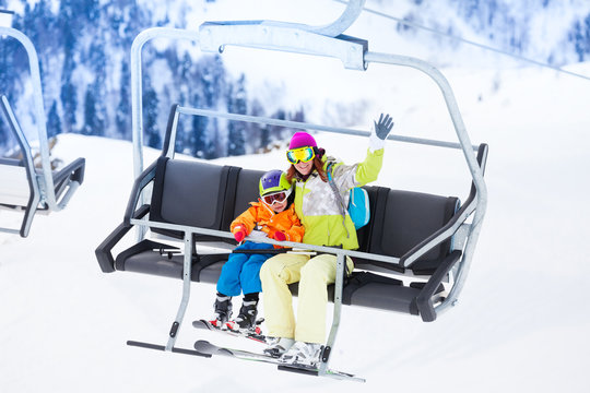 Mother with boy lifting on ski lift