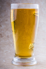 full glass of beer on stone background