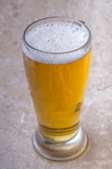 top view of glass of beer on stone background