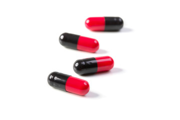 black and red medicine pills isolated on white background