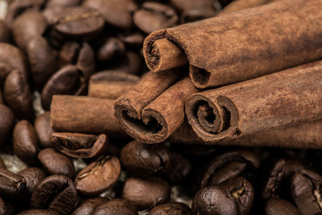 coffee beans with cinnamon sticks on sack textile