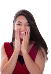 Beautiful biracial teen girl in red dress excited, hands on face