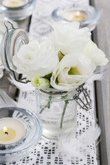 Tiny bouquet of white eustoma flowers and green hypericum plant