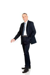 Full length businessman leaning on empty blank