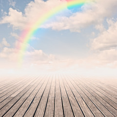 pier with rainbow on sunset