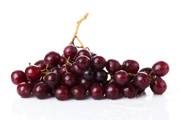 Fresh red grapes and water drops isolated on white background
