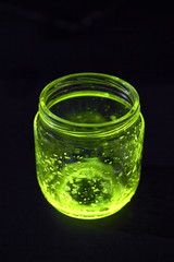 Open glowing jar in the darkness