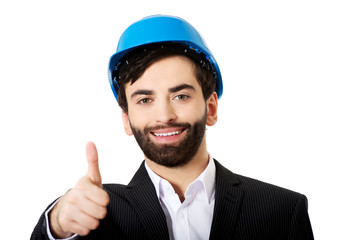 Engineer in protective helmet with thumbs up.