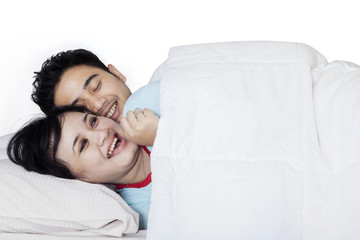 Couple having fun on bedroom