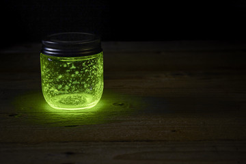 green glowing jar on the boards