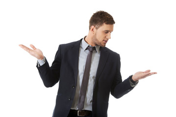 Handsome businessman holding copyspace on palm.