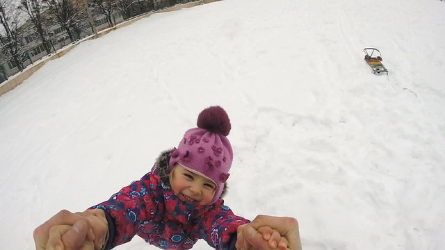Happy Child  Rotates and Fall on the Snow, Slow Motion