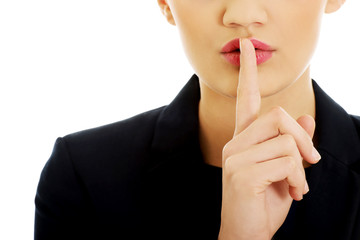 Naklejka premium Businesswoman with her finger on lips.