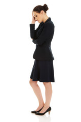 Tired businesswoman touching her head.