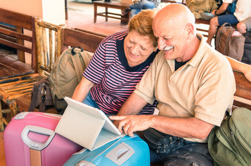 Fototapeta na wymiar Happy senior couple sitting with digital laptop