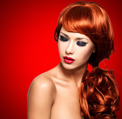 Fototapeta premium Beautiful woman with long red hairs and bright eye makeup
