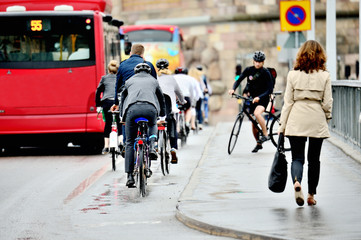 Commuters on their way home on bikes in the rain