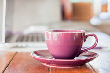 Purple coffee cup on work station
