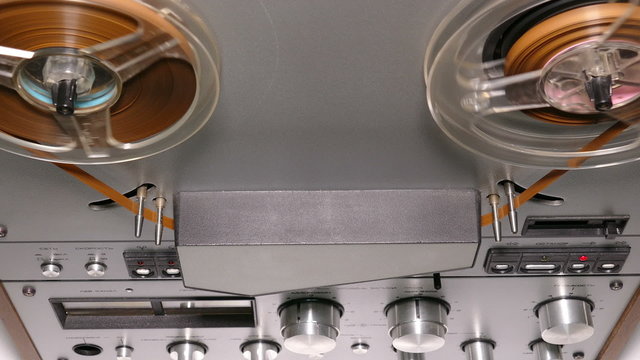 old reel tape recorder with spinning reels