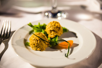 white platter with tuna appetizer and salad