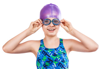 Portrait of a young girl in goggles and swimming cap.