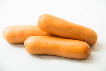 Appetizing fresh sausage on white background