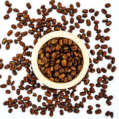 Coffee beans in wooden bamboo mortar isolated on white