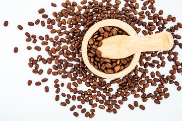Coffee beans in wooden bamboo mortar isolated on white