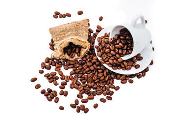 white cup with coffee beans isolated