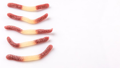 Brown and white sugar jelly candy strip over white background