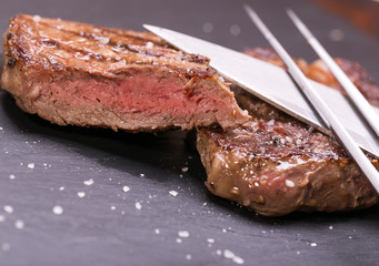 fresh, grilled beef steak on wooden background 
