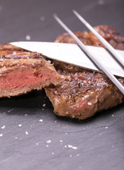 fresh, grilled beef steak on wooden background 