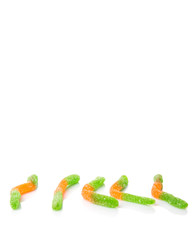 Green and orange sugar jelly candy strip over white background