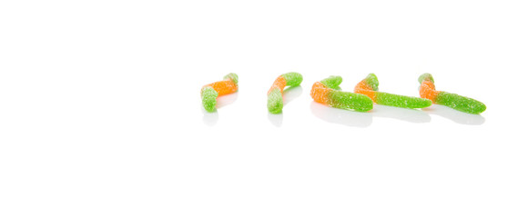 Green and orange sugar jelly candy strip over white background