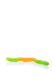Green and orange sugar jelly candy strip over white background