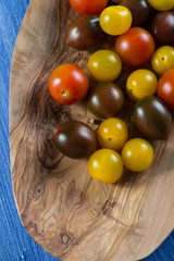 Colorful baby tomatoes on vibrant wooden background