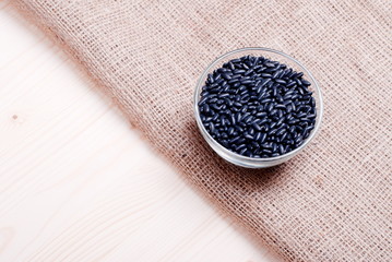 Fototapeta premium raw black beans on the board diet food
