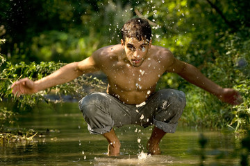 Man in river washing face