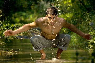 Man in river washing face