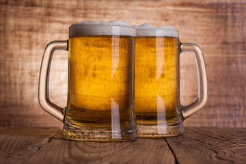 Glass beer on wood background