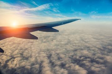 Fototapeta na wymiar Wing of the plane on blue sky background